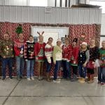 Picture of a dozen IFS employees dressed up in ugly sweaters for Christmas